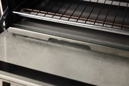 Grease on the back of the stainless steel Breville BOV450XL Mini Smart Toaster Oven’s glass door.