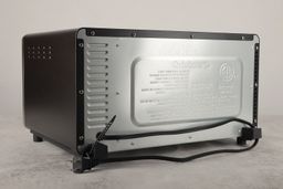 The back and left sides of the Cuisinart TOB-40N have air ventilation holes. The back has a power cord and two buffers.