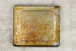 Permanent stains on the silver baking pan of the Hamilton Beach 31401 4-Slice Countertop Toaster Oven on a grey background.Permanent stains on the silver baking pan of the Hamilton Beach 31401 4-Slice Countertop Toaster Oven on a grey background.