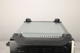 On a grey background, the bottom of the Toshiba AC25CEW-BS Toaster Oven has two black stands and air ventilation holes.