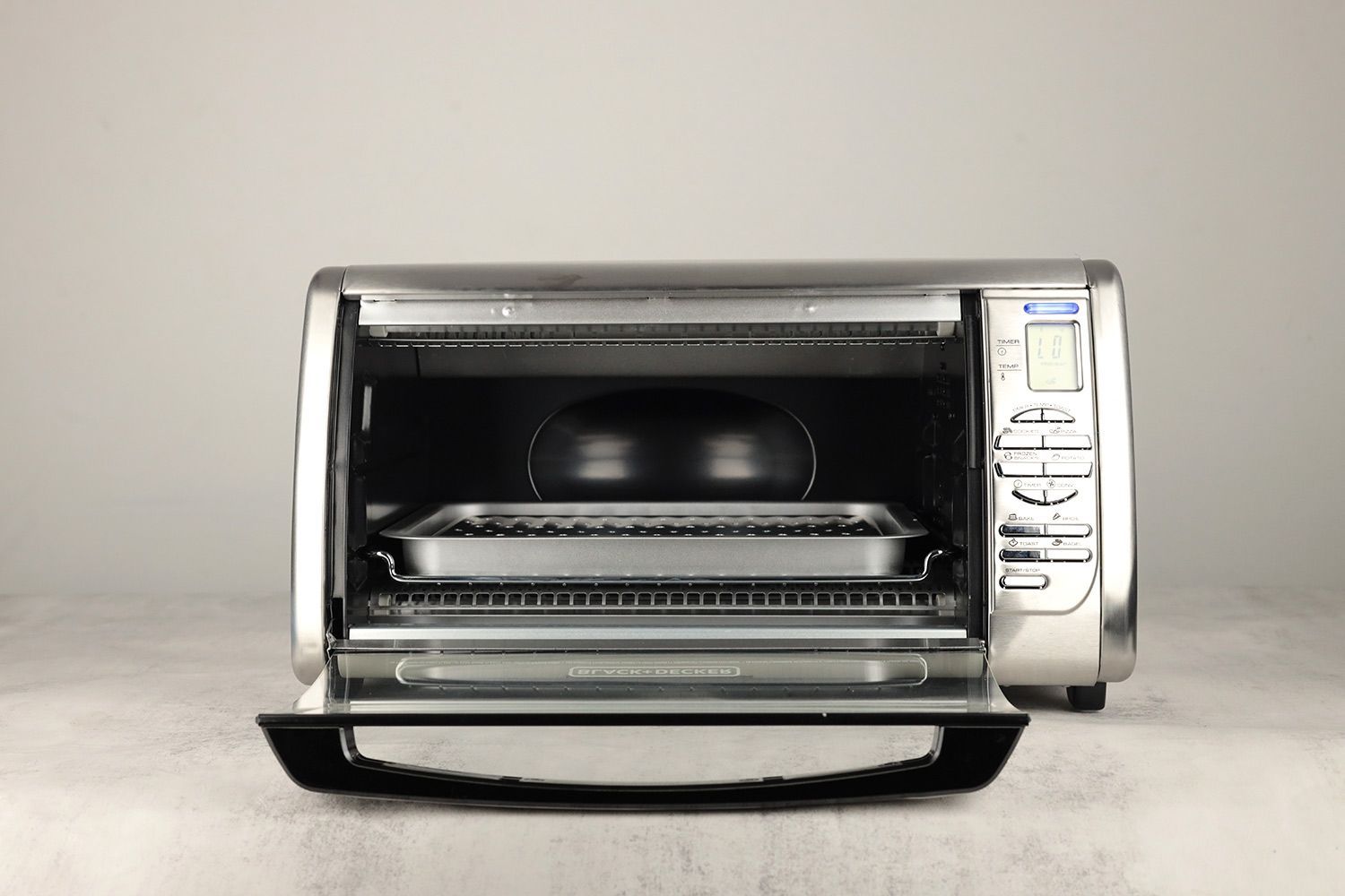 The front of an opened BLACK+DECKER CTO6335S Convection Toaster Oven with a baking rack, a baking pan, and a broiling rack