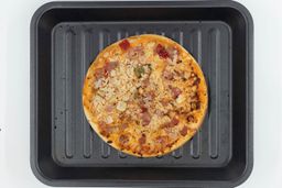 Cosori Air Fryer Toaster Oven PizzaA toaster oven baked 9-inch thick-crust meat pizza with cheese, onions, and green bell peppers on top inside a baking pan.