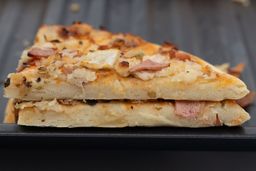 Two slices of oven baked 9-inch thick-crust meat pizza with cheese, onions, and green bell peppers on top of one another.