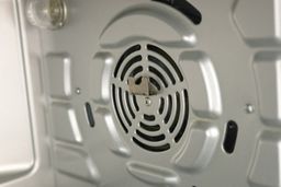 The cleaned cooking chamber’s right wall of the Cosori CO130-AO Toaster Oven with some stains behind the rotisserie bracket.