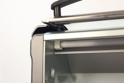 The opened roll top door and upper heating element with a guard of the silver Hamilton Beach 31344DA 4-Slice Toaster Oven.