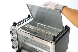 The detached crumb tray of the stainless steel Black+Decker TO1760SS 4-Slice Countertop Toaster Oven on a white background.