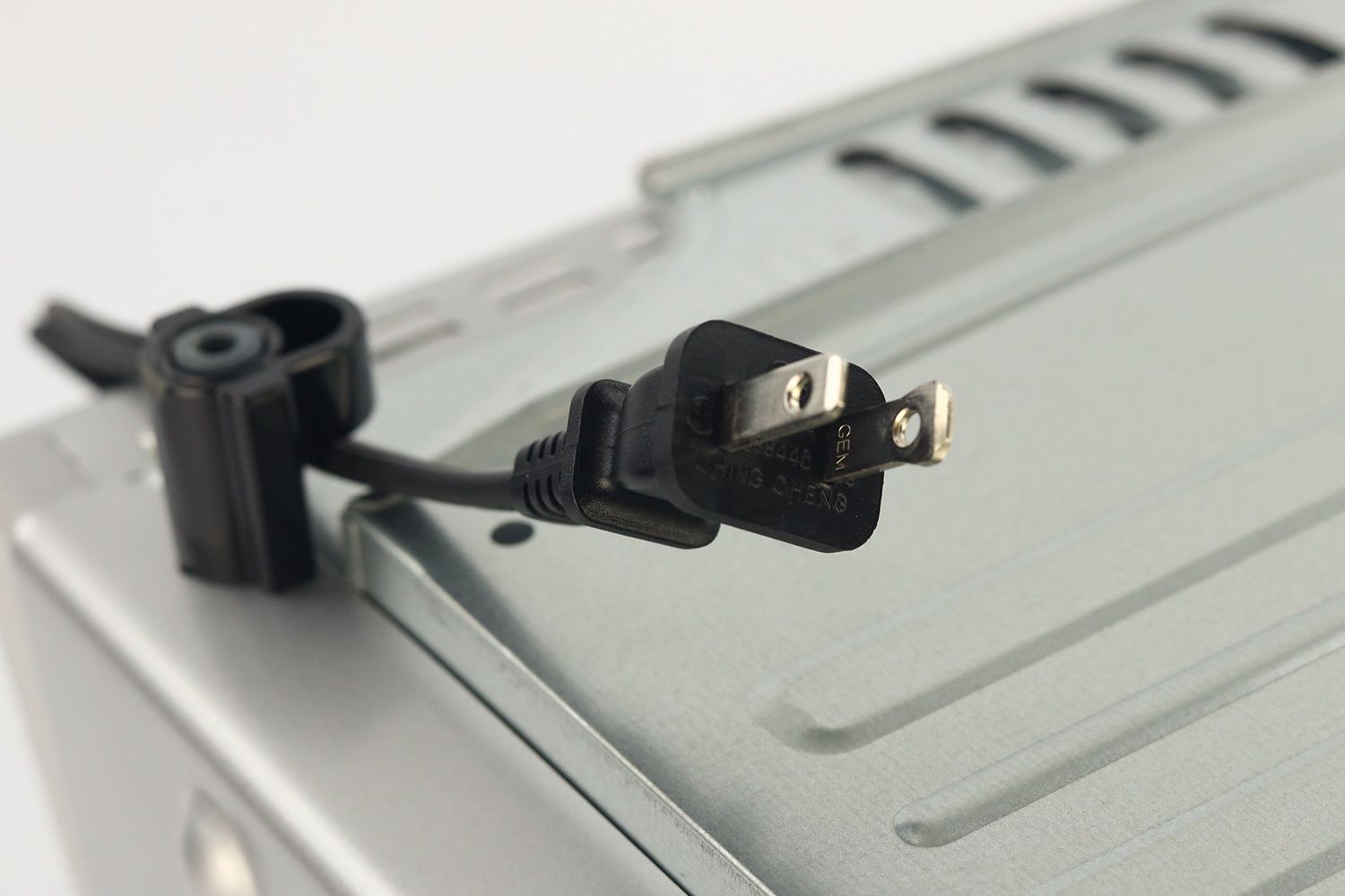  A two-pronged plug power cord of the silver stainless steel Panasonic NB-G110P FlashXpress Compact Toaster Oven.