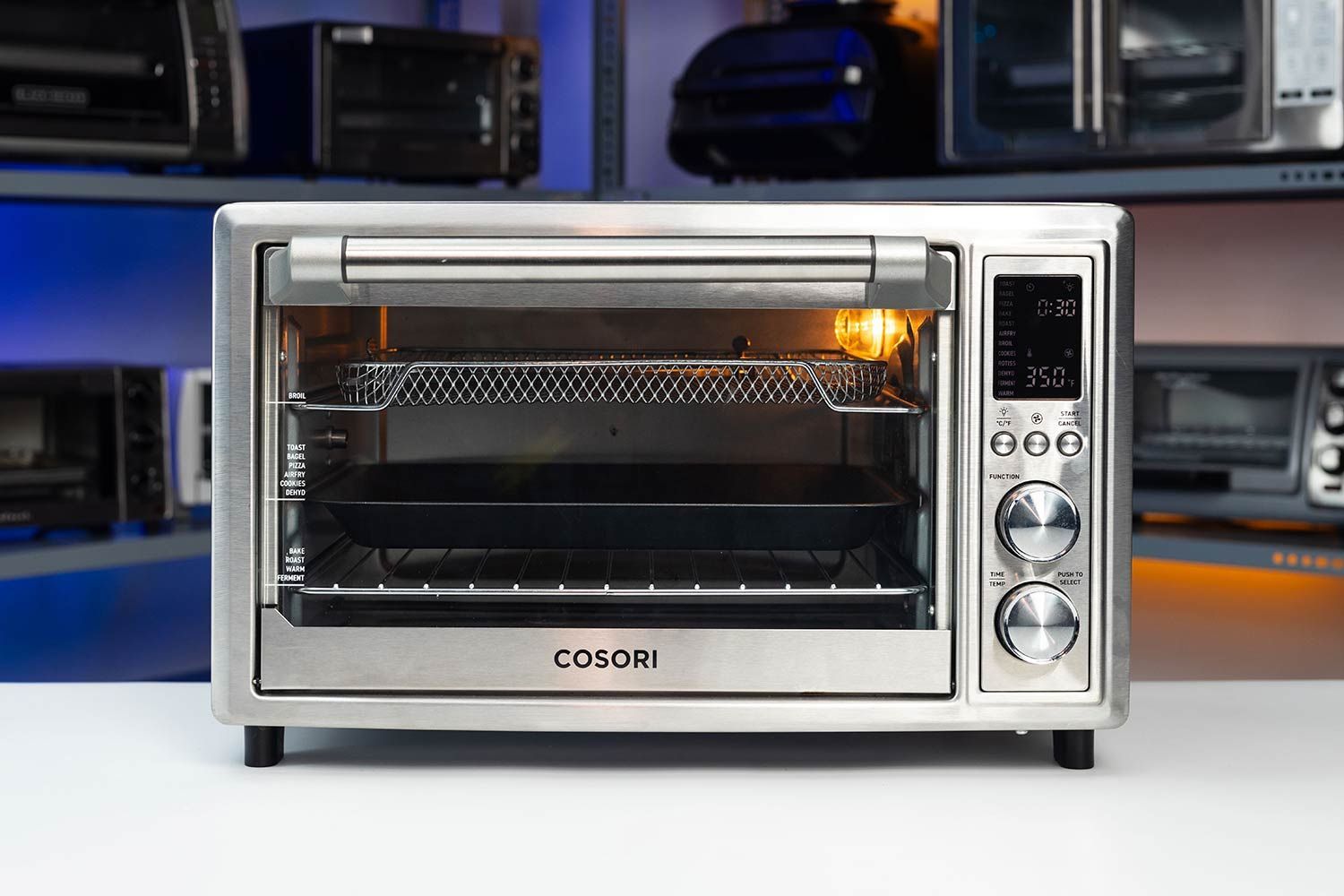 The front of a closed Cosori CO130-AO 30L 12-In-1 Dehydrator Air Fryer Rotisserie Toaster Oven on a white background.