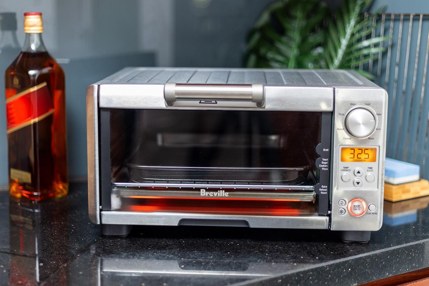 The front of a closed stainless steel Breville BOV450XL Mini Smart Toaster Oven on a white background.