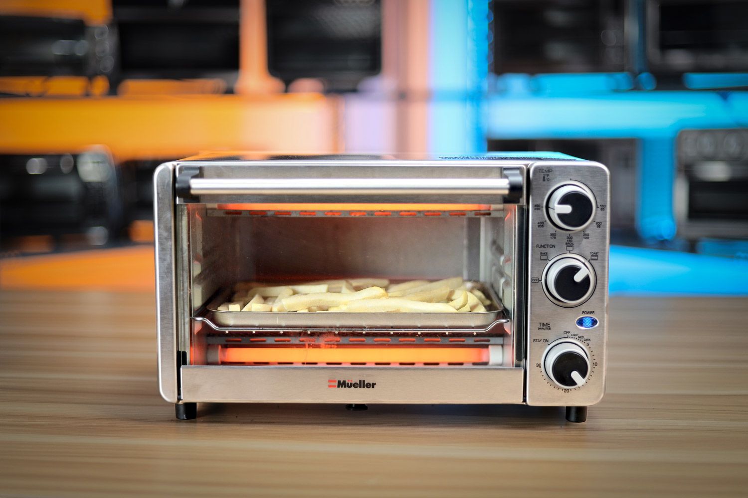 The front of a closed stainless steel Mueller MT-175 4-Slice Countertop Toaster Oven on a white background.