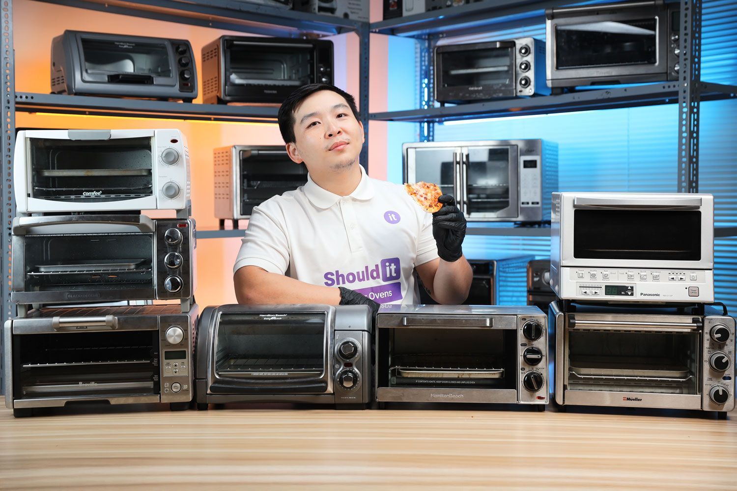 Alan Nguyen sharing his hard-earned pizza from testing Small Toaster Ovens in ShouldIt's lab.