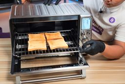 Alan from ShouldIt taking out a rack of 4 slices of golden brown toast from the Breville BOV900BSS Smart Oven Air Fryer Pro.