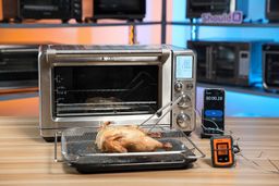 Using a basket and baking pan to air-fry a 3-lb whole chicken at 350°F in 50 min using the Breville BOV900BSS Smart Oven Air Fryer Pro. The internal temperatures reach 182-198°F.
