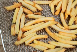 A close-up of a basket containing 12 oz of air-fried fries