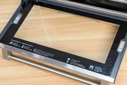 Safety precautions for users of the Breville BOV900BSS Smart Oven Air Fryer Pro on the inside of the glass door.