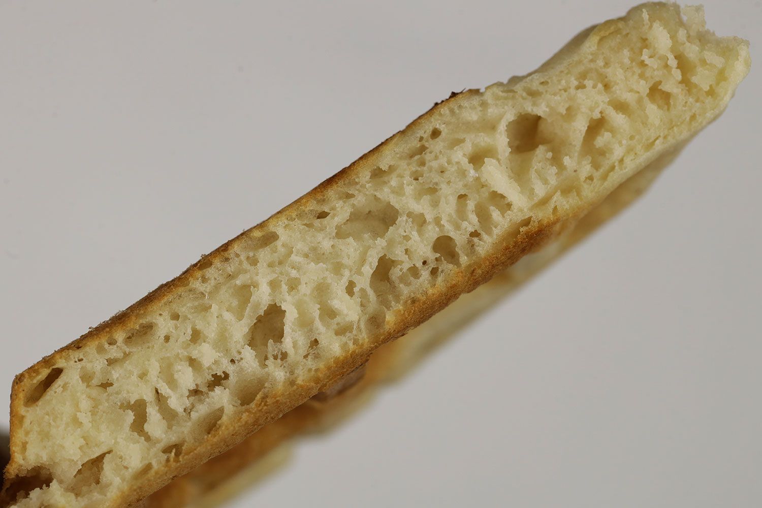 The interior of a waffle baked for 3 minutes using a Birch Benders batter mix. Small air cavities can be seen within.