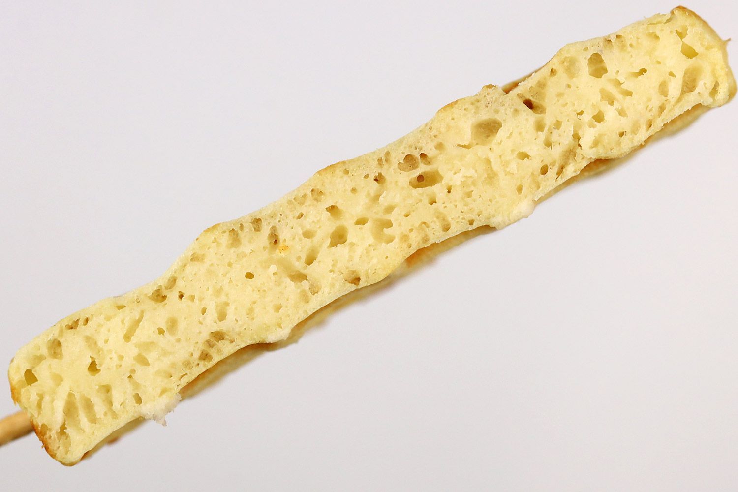 A cross-section of a waffle baked for 5 minutes using our self-mixed recipe. Prominent air bubbles can be seen within.