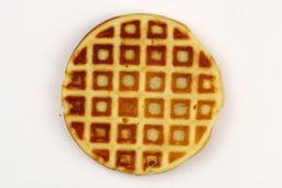 A waffle baked for 5 minutes using our self-mixed recipe. Presented here is its bottom crust with a very dark brown color.