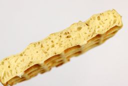 A cross-section of a waffle baked for 5 minutes using our self-mixed recipe. Prominent air bubbles can be seen within.