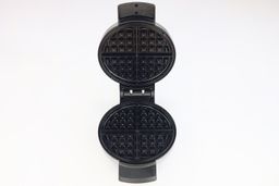 An overview of the glossy, black, Belgian-style waffle plates of the Black and Decker WMB500 waffle maker.