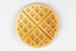 The light gold bottom of a waffle cooked by the Hamilton Beach 26031 waffle maker in 6 minutes using the Birch Benders mix.