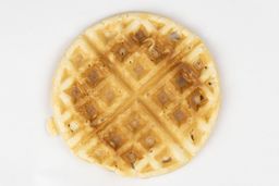 The very light gold-dark brown top crust of a waffle baked for 3 minutes using a batter made from the Birch Benders mix.