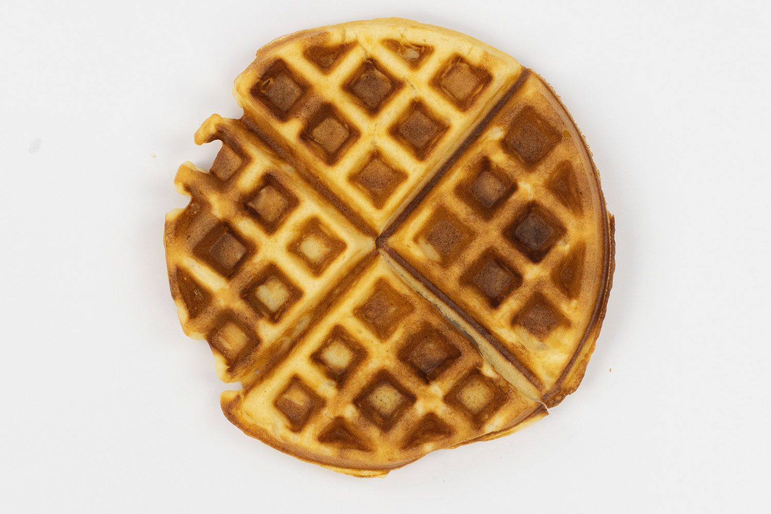 The very dark brown top crust of a waffle cooked in 5 minutes.