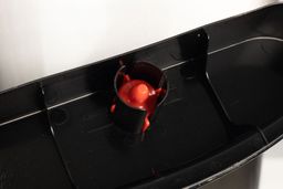 Close up of a red water float in the drip tray of a water cooler dispenser.