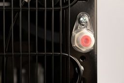 A close up image of a safety screw cap covering the drainage outlet for a water cooler dispenser. 