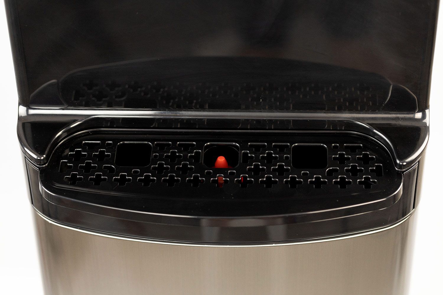 A black colored drip tray with a red bobble float found on a water cooler dispenser.