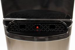 A black colored drip tray with a red bobble float found on a water cooler dispenser.