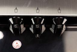 A close-up view of three water nozzles on a water cooler dispenser molded into the panel roof.