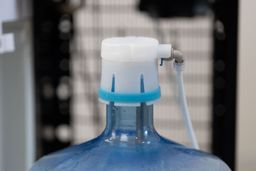 Close up of a bottle cap on a 5-gallon water jug of a bottom-loading water cooler dispenser.