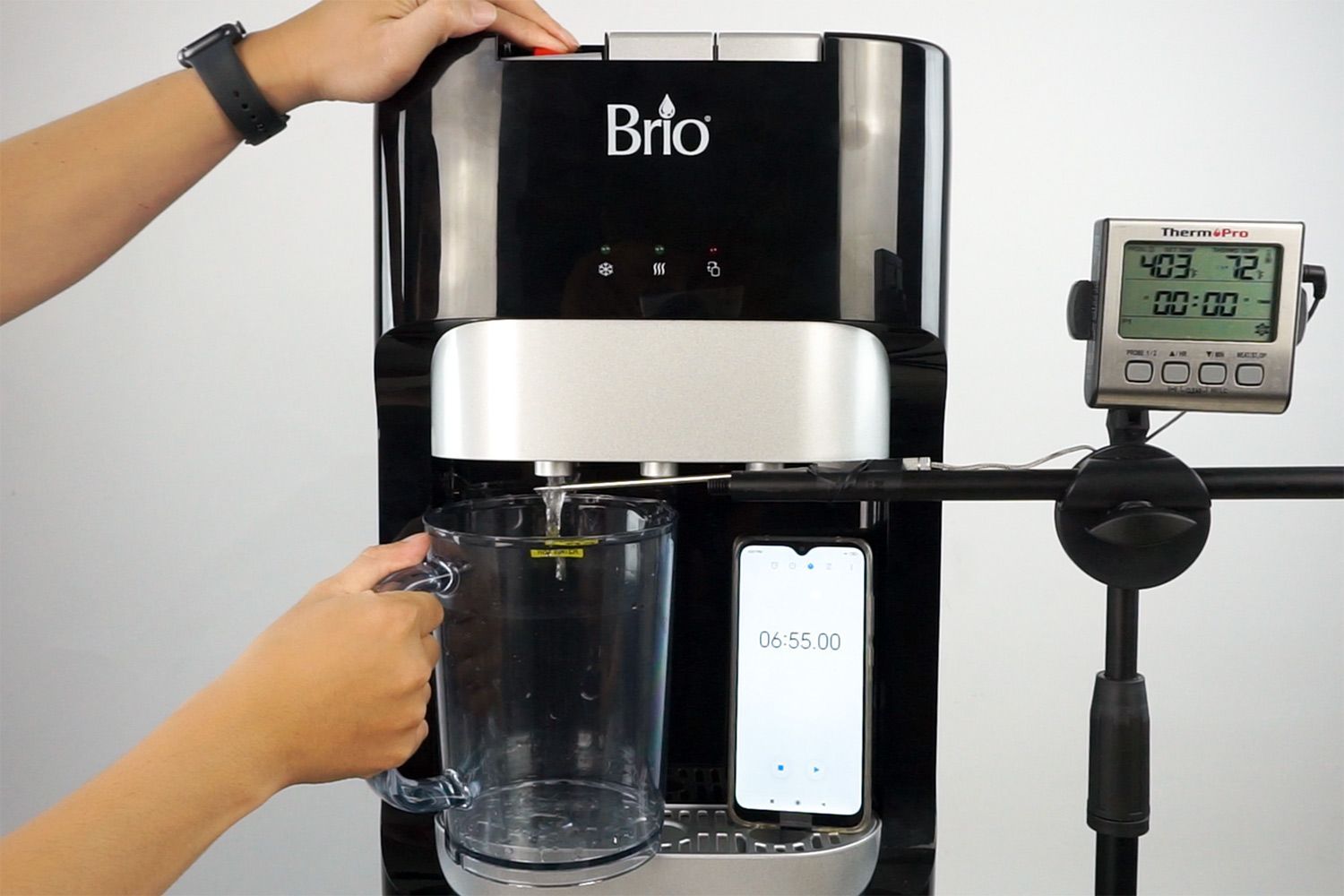 Water temperature being measured as hot water flows out the nozzle of a water cooler dispenser.