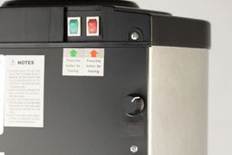 Close up of the rear of the Frigidaire  EFWC519 water cooler showing a temperature adjustment button on the bottom right.