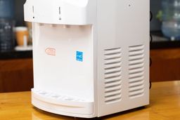 A front to angle view of the Igloo bottled water cooler dispenser showing side ventilation slats.