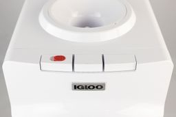 A close up top down view of three white buttons of a water cooler dispenser.