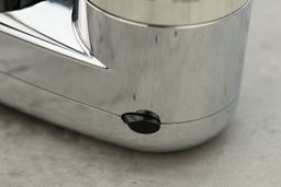 A side view of the Brita Basic faucet-mount water filter, revealing the small, black, plastic filter release button.