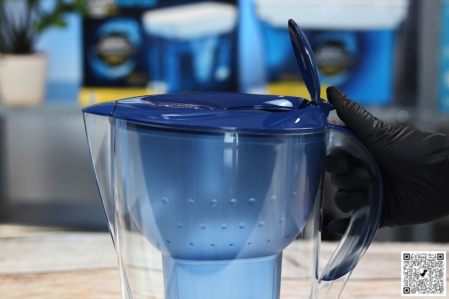 Gloved hand flipping open the refill door on the Brita Marella XL