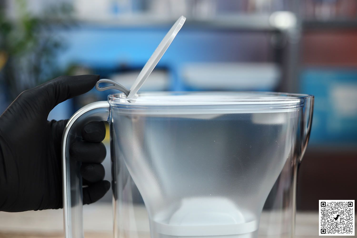 Gloved hand flipping open the refill door on the Brita Style