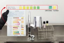 The Culligan FM-25 filter mounted on a tap. To its left is the testing result pad with two activated test strips.