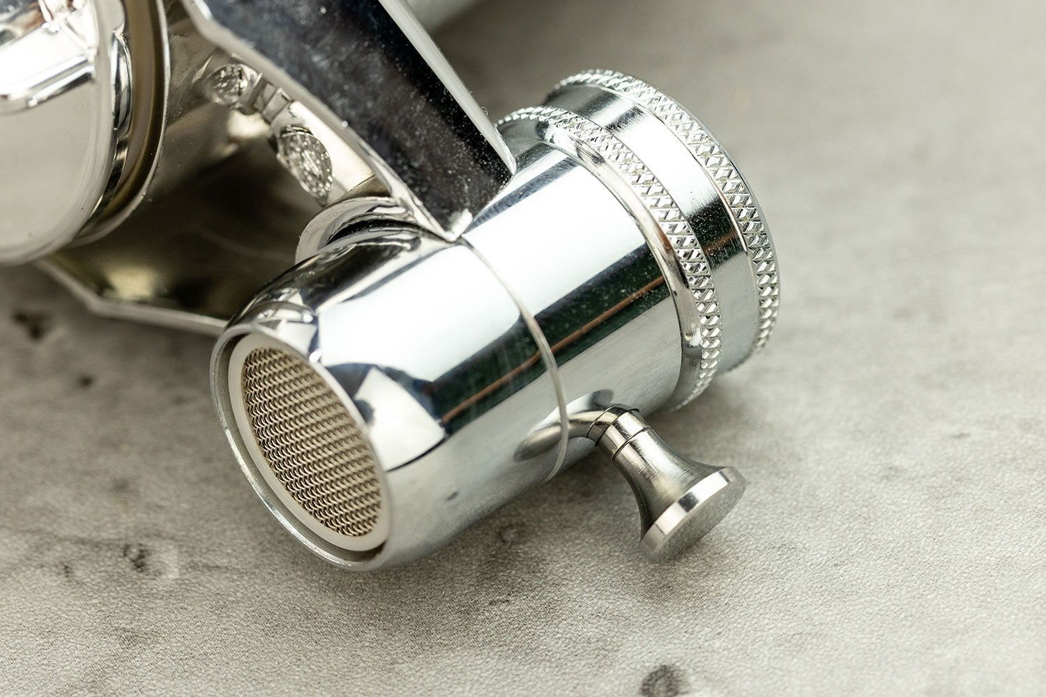 A close-up view of the push-pull routing valve on the side of the Culligan FM-25 faucet-mount water filter.