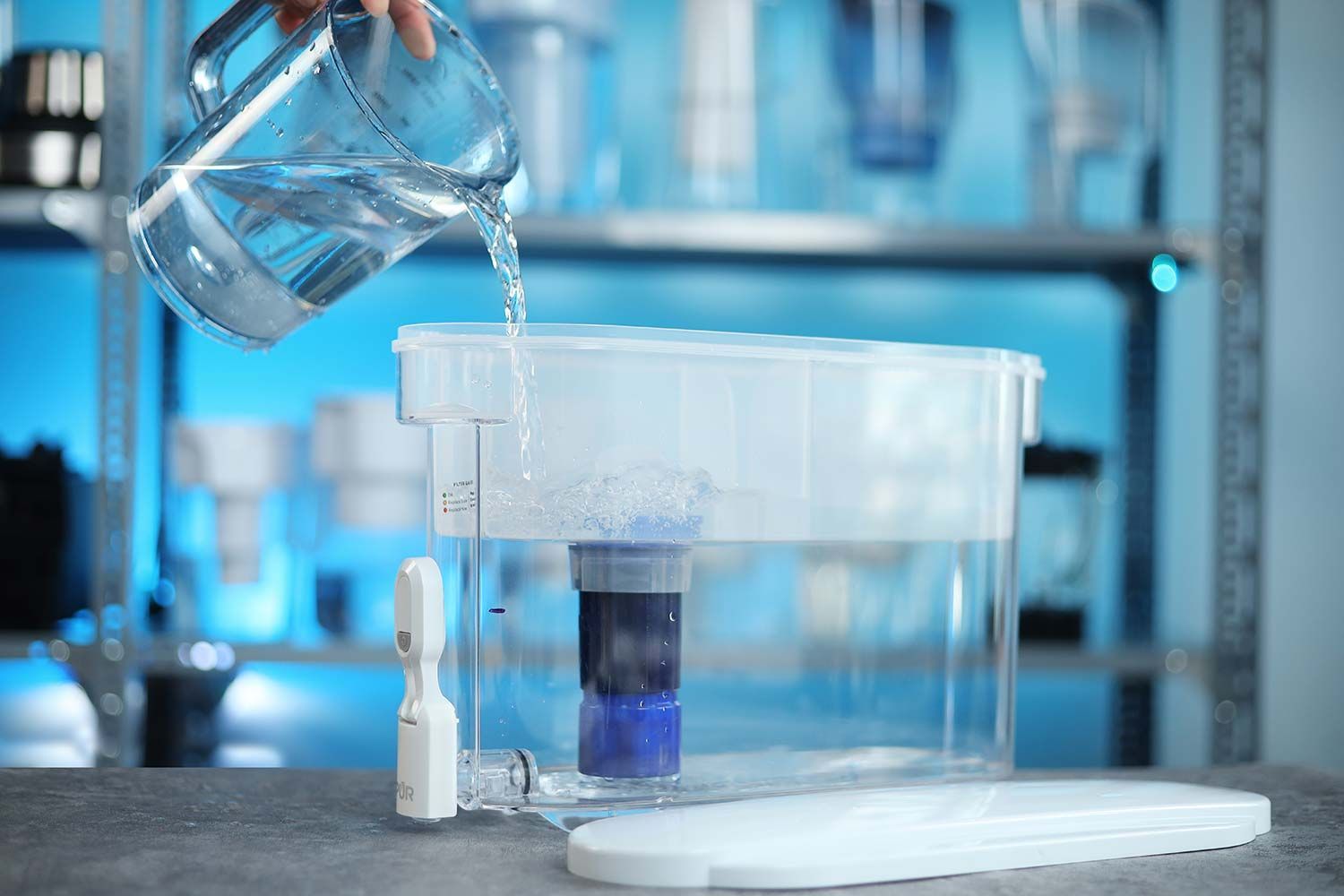 Water being poured from a container into the PUR Plus dispenser reservoir