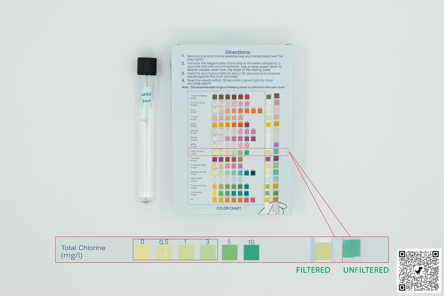 Test tube containing water labeled Waterdrop next to water test kit box with two test strips on top