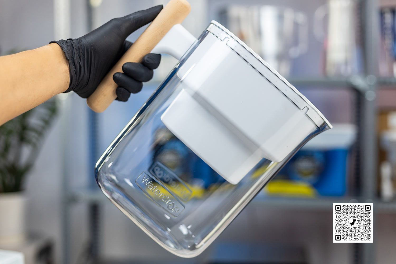 Gloved hand holding the Waterdrop Chubby water filter pitcher