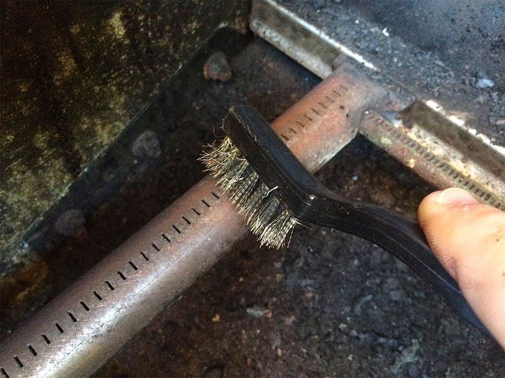 Scrubbing the holes on the burner